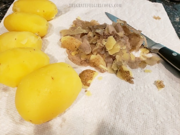 After being par-boiled, the potatoes are peeled.