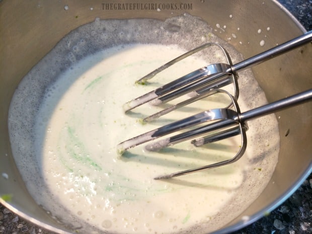 A drop of green food coloring is added to the mousse ingredients.