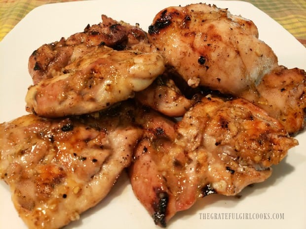 Honey lime grilled chicken pieces on a white platter, ready to be eaten.