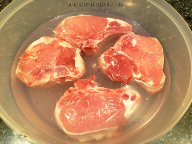 The pork chops are refrigerated overnight in a sweet/salty brine.