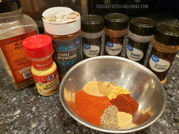 Spices are combined to make a dry rub for pork chops.