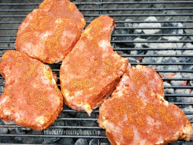 The chops are cooked on the bbq grill over hot coals.