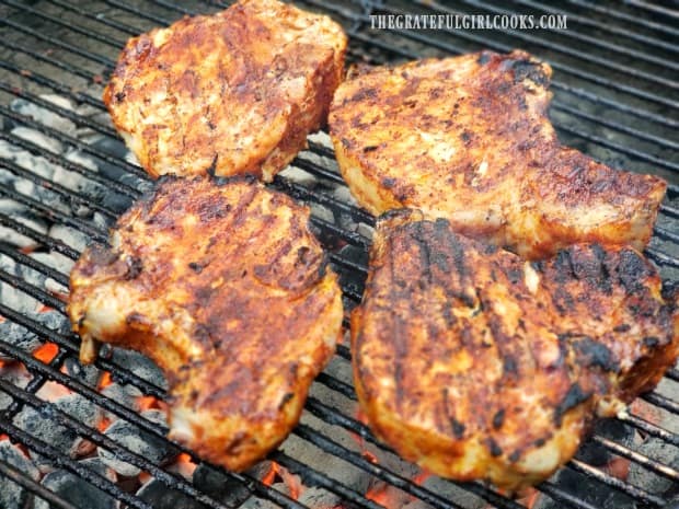 Awesome grilled pork chops are cooking and well browned on the bbq.