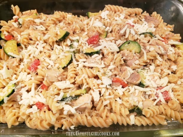 Parmesan and mozzarella added to top of the chicken pasta casserole, before baking.