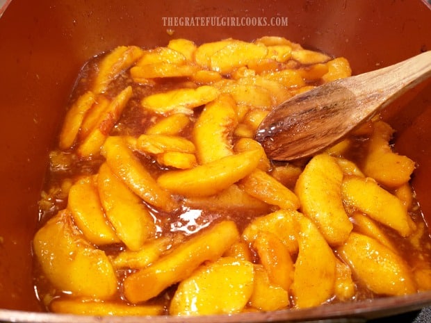 Peach cobbler filling is brought to a boil, then removed from heat.