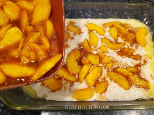 The cobbler filling is poured or spooned over the batter in baking dish.