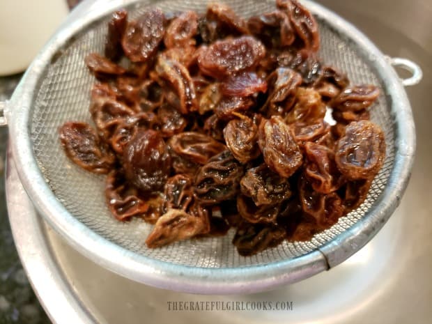 The raisins are drained after being plumped up in boiling hot water.