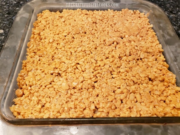 Remaining half of krispy mixture is packed on top of the chocolate layer.