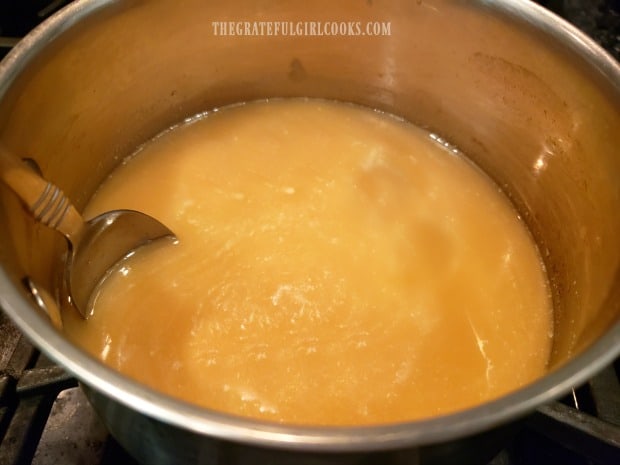 Apple cider and vanilla are added to the saucepan and heated through.