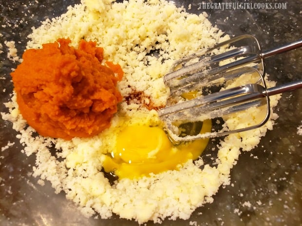 Pumpkin puree, egg, and vanilla are added to creamed butter mixture.