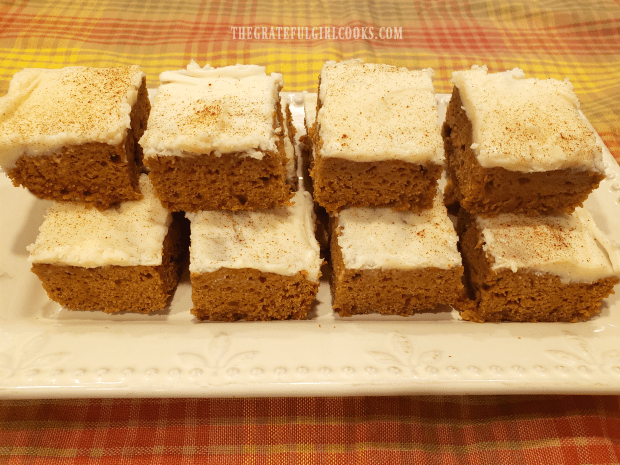 Long platter of stacked, frosted pumpkin bars, ready to enjoy!