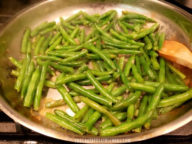 The green beans are cooked about 10 minutes until broth has dissipated.