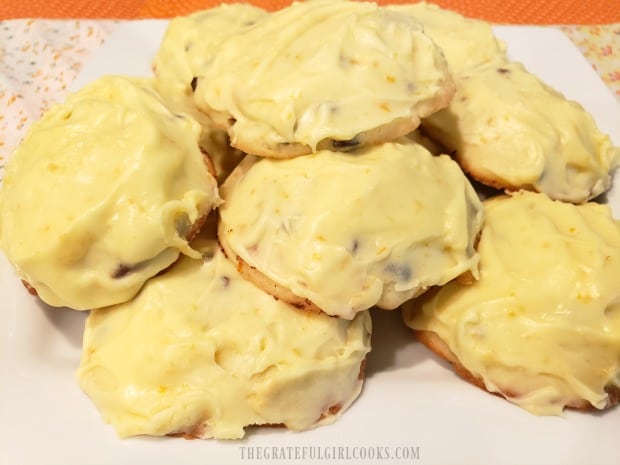 A plate of frosted orange chocolate chip cookies, ready to enjoy!