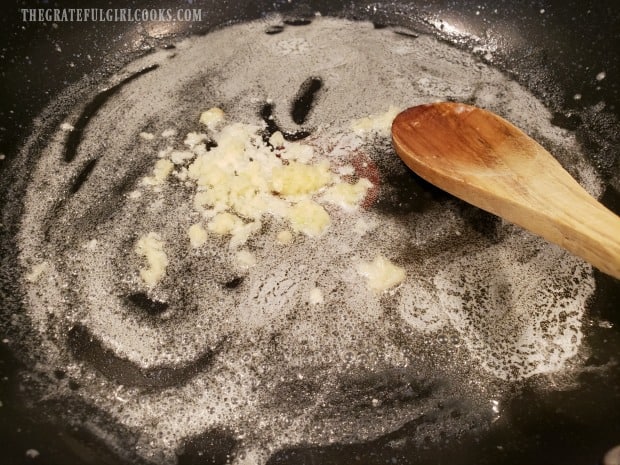 Minced garlic is quickly cooked in melted butter to begin making the sauce.