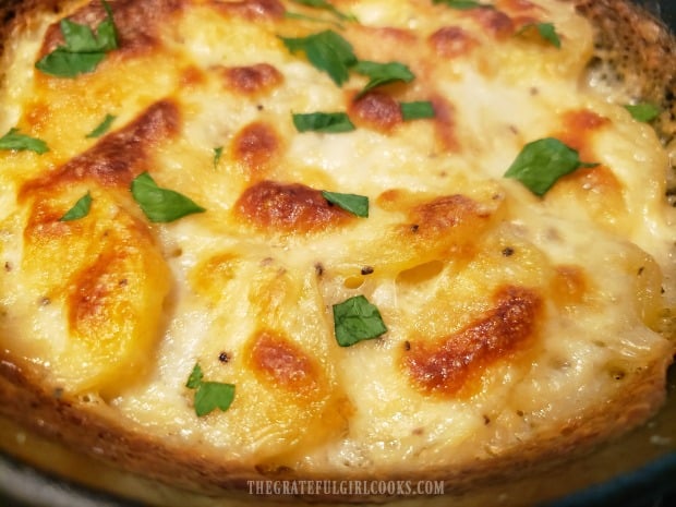 Fresh chopped parsley is used to garnish the Scalloped Potatoes For Two.