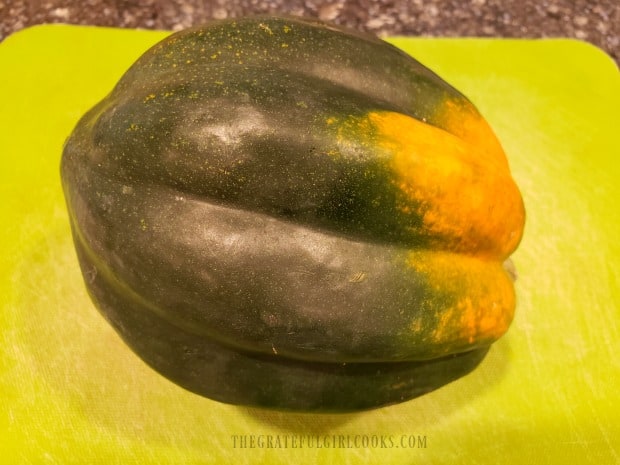 A whole acorn squash, before de-seeding and slicing.