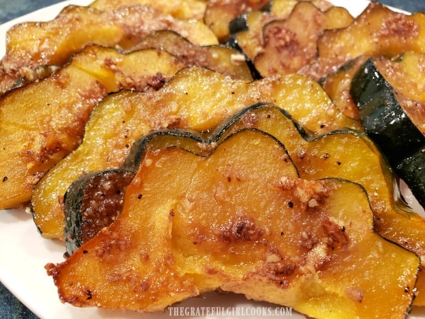 A serving plate full of baked praline acorn squash, baked and ready to eat.