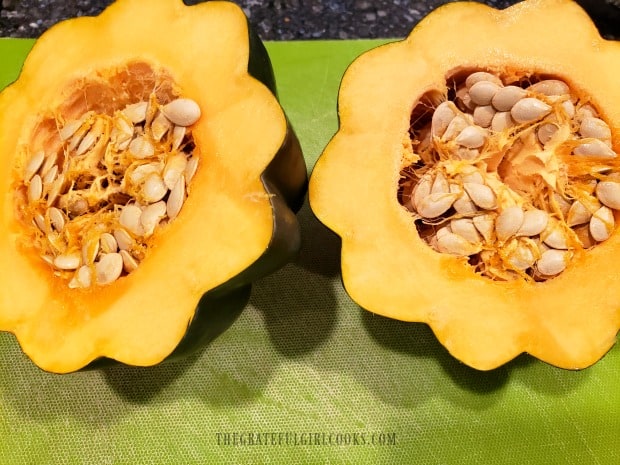 After slicing the squash in half, the seeds need to be removed.