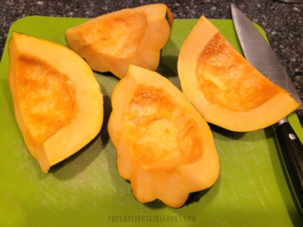 Each of the acorn squash halves are then cut in half, making 4 quarters per squash.