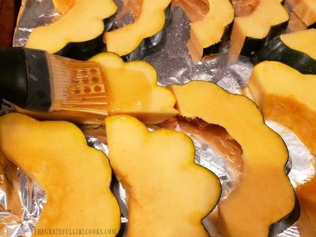 Raw slices of squash are brushed with an olive oil/maple syrup mixture.