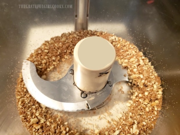 Pecans, brown sugar, salt, pepper, and cayenne pepper are finely ground in a food processor.