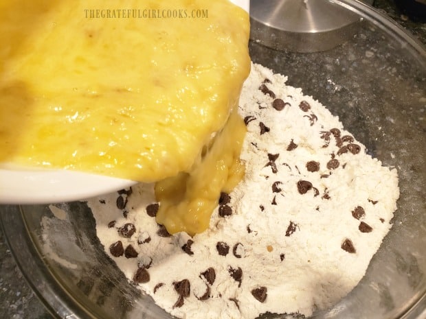 The wet ingredients are poured into the bowl of dry ingredients.