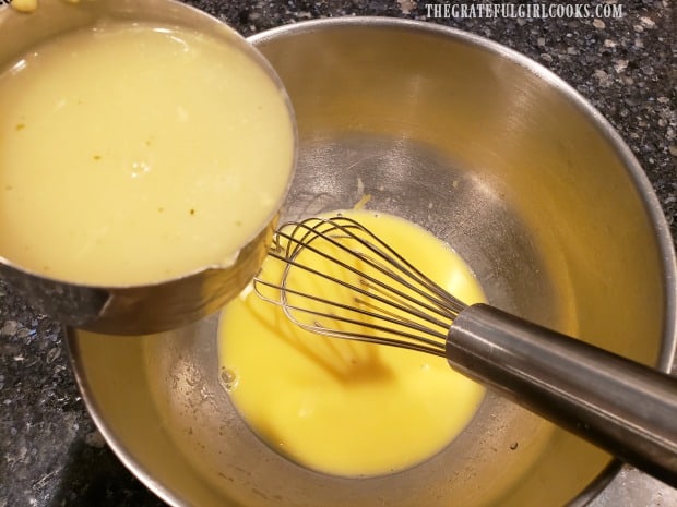 Hot broth is slowly drizzled/whisked into egg mixture to temper the eggs.