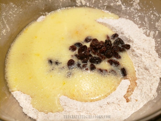 Wet ingredients and rum-soaked raisins are added to dry ingredients.