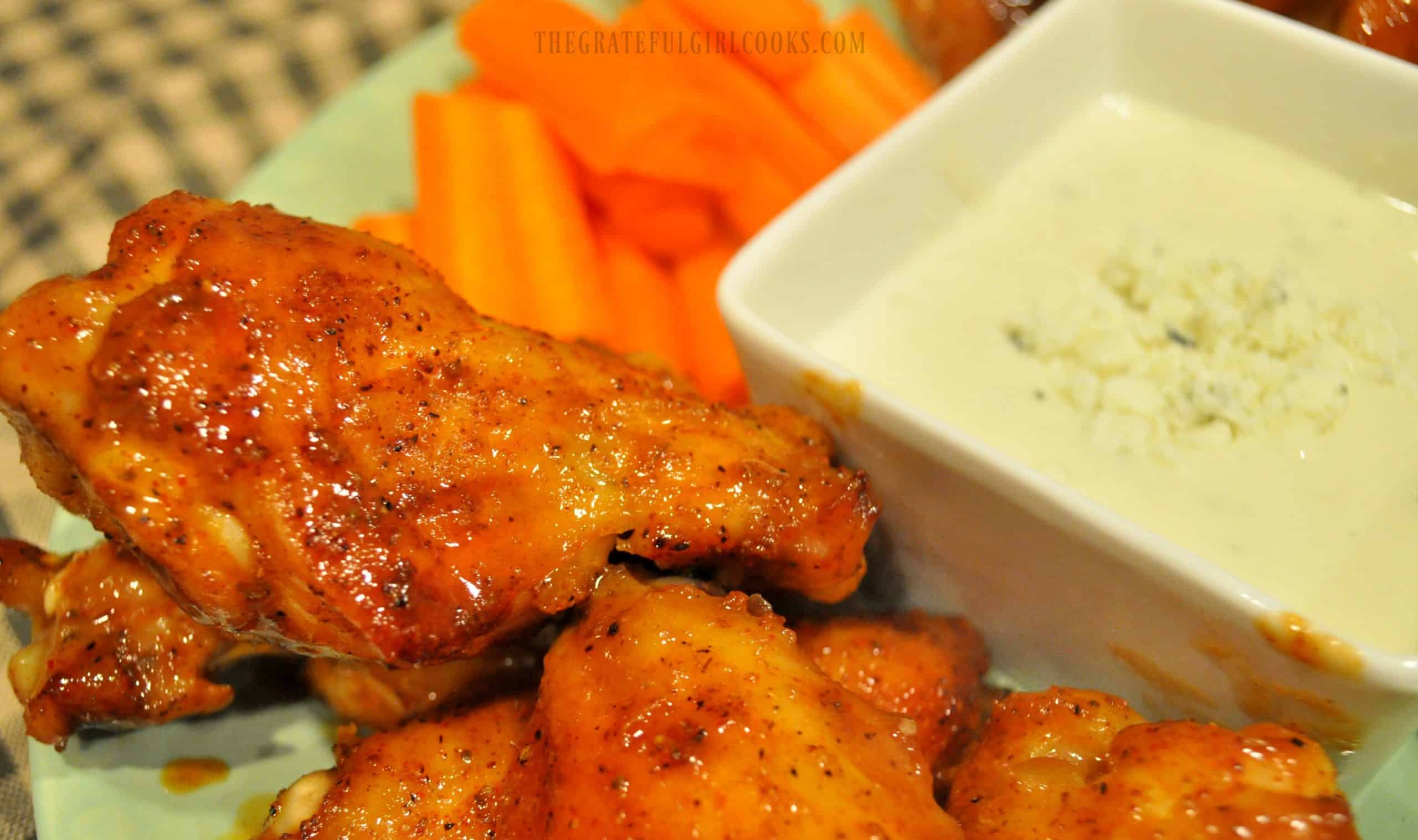 Carrots and dip are served with the cooked buffalo honey chicken wings.