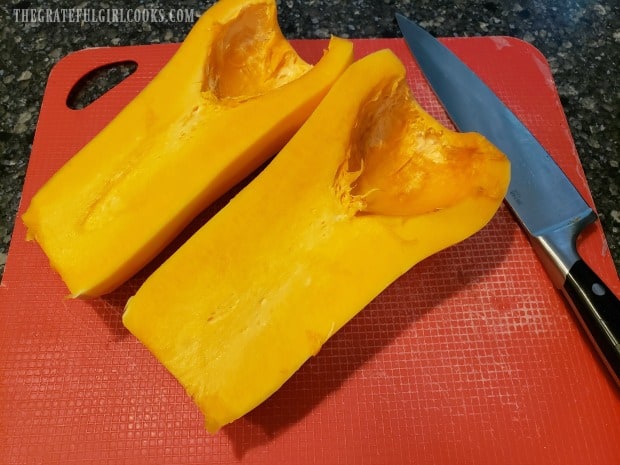 A butternut squash is sliced in half lengthwise, then seeds are removed.