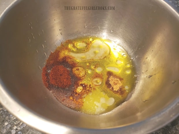 Olive oil, lime juice and spices are combined to make sauce for tortilla chips.