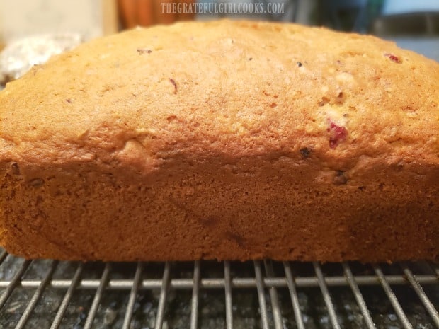 A side view of the finished loaf of bread while cooling on wire rack.