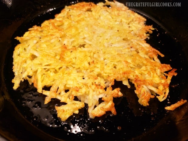 The crispy homemade hash browns are cooked, then flipped to cook other side.