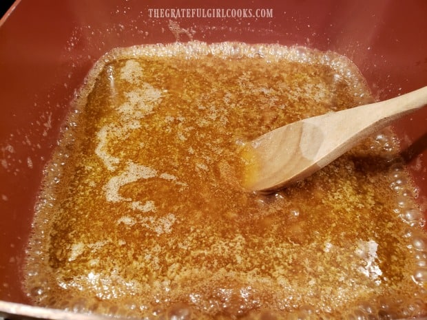 Caramel sauce ingredients are cooked in large saucepan.