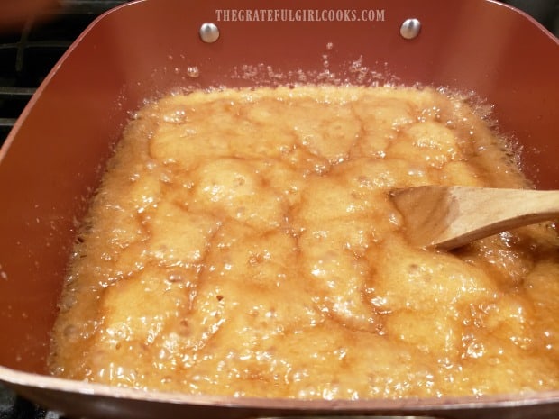 Crunchy caramel corn sauce is boiling in pan.