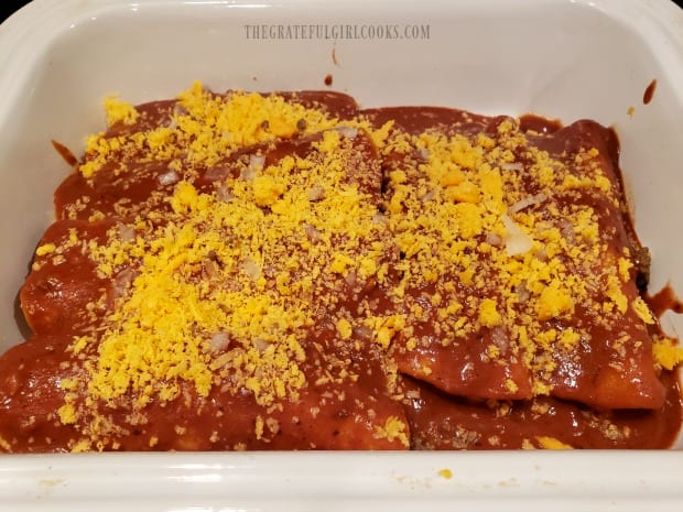 A baking dish of enchiladas covered in easy homemade enchilada sauce.