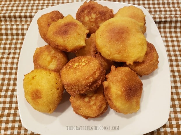 A white plate full of Mom's southern hush puppies, ready to eat!