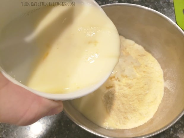 Milk and egg mixture is added to dry ingredients in bowl.