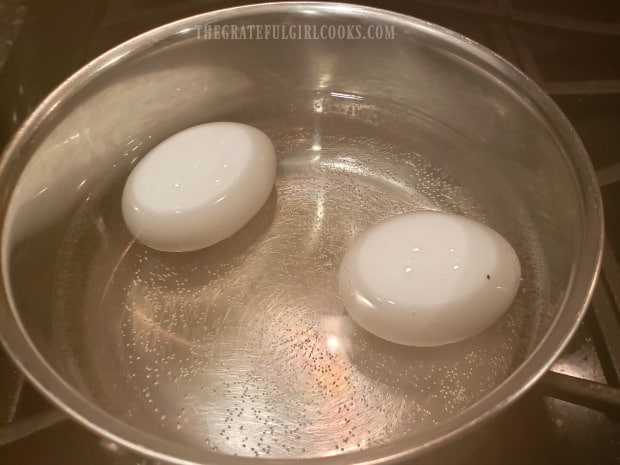 Hard-boiled eggs are used in this recipe for spinach salad.