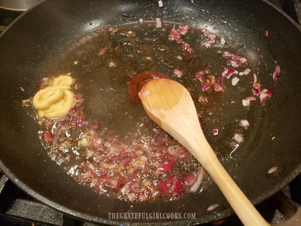 Vinegar, Dijon mustard and maple syrup is added to the cooked red onion.