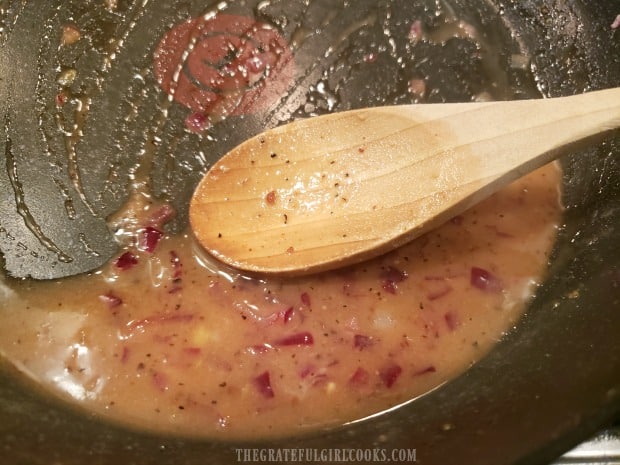 Warm bacon dressing is heated until sugar dissolves.