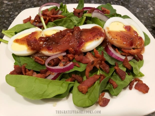 Crispy bacon, hard-boiled eggs, red onion, and warm bacon dressing on each salad.