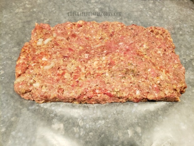 Half of the meat mixture is formed into a rectangular shape.