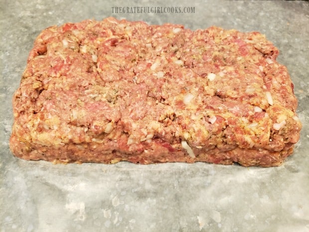 Top layer of meatloaf mixture is now covering the bottom half and cheese layer.