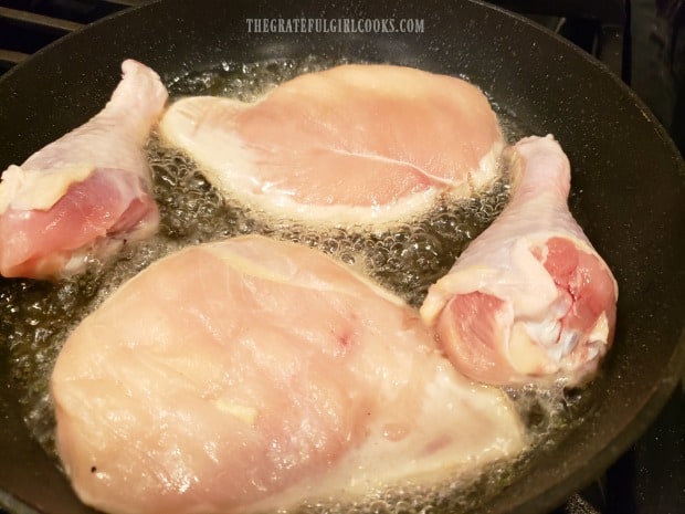 Chicken pieces are lightly browned in hot oil on both sides.