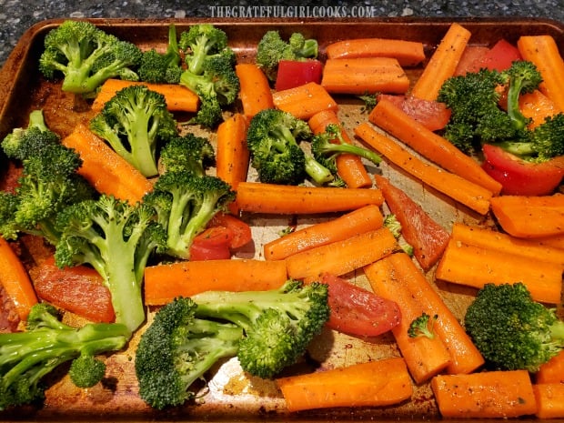 Seasoned vegetables are baked in an oven for ten minutes before turning.