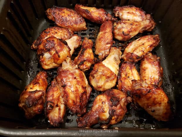 When halfway done, Asian BBQ chicken wings are flipped over to finish cooking.