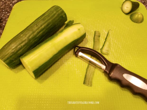 The cucumbers are washed, ends trimmed off, then peeled.