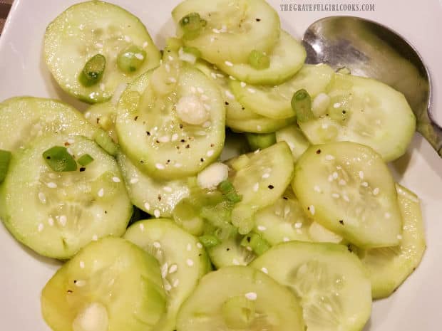 A close up photo of the Asian Cucumber Salad in a white bowl.