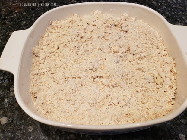 Crumb topping is sprinkled onto the Blueberry Cranberry Crisp before baking.